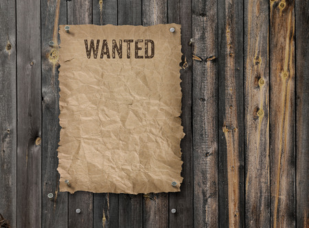 Wild West wanted poster on weathered plank wood wallの写真素材
