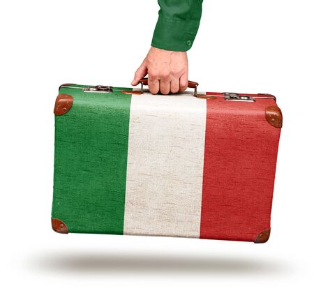 Hand holding vintage Italian flag suitcase isolated on whiteの写真素材