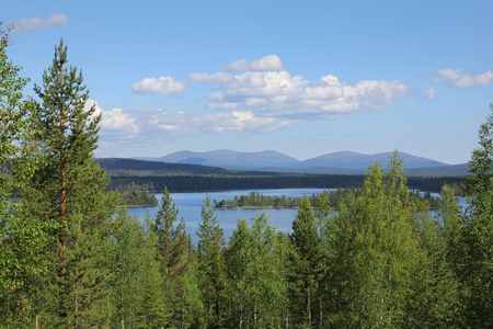 Finnish Lapland summer lake scenery with Pallastunturi fells on the horizonの写真素材