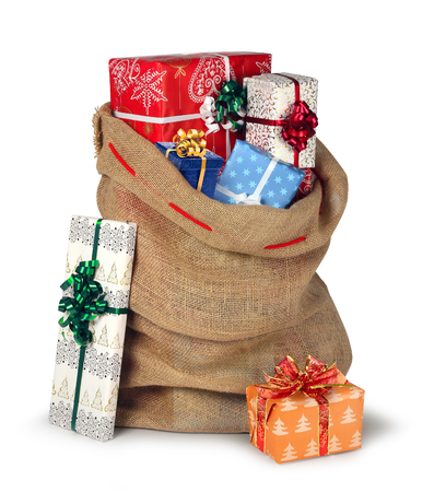 Santas Christmas present burlap sack full of beautiful present boxes isolated on whiteの写真素材