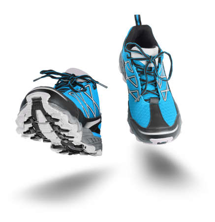 Running blue sport shoes seen front, isolated on white backgroundの写真素材