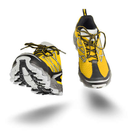 Yellow running sport shoes seen front, isolated on white backgroundの写真素材