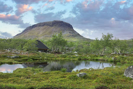 Saana fell and trekker's hut in summer evening light, seen from Lake Tsahkalの写真素材