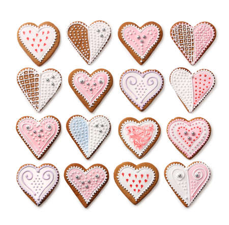 Sweet Christmas heart shaped gingerbread cookies collection with colorful sugar icing decoration, isolated on white backgroundの写真素材