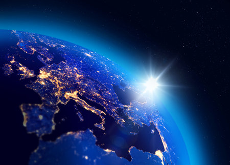 Illustration of the sunrise over Planet Earth, European city lights visible. Energy consumption concept.の写真素材