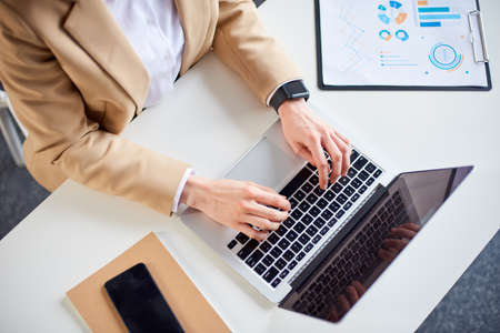 Mid age businesswoman working at the laptop in office