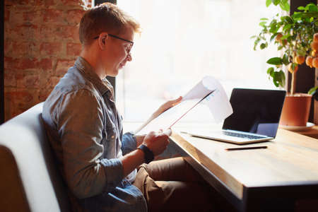 Man writing in the notes he made earlier.の写真素材