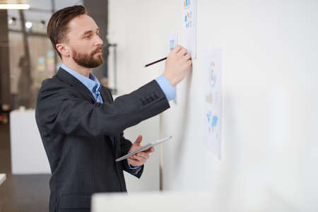 mid age businessman working on new project at modern officeの写真素材