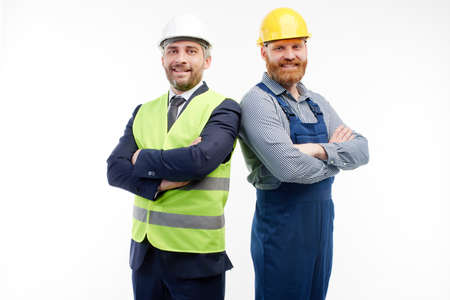 Engineer and foreman looking at camera on white backgroundの写真素材
