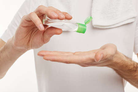 Closeup. A man uses antiseptic for hands.