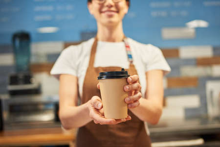 Barista gives a ready order to a guest.の写真素材