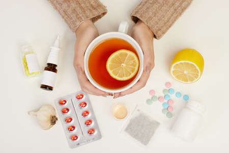 Close-up of a cup of tea with a lemon slice shot on the white backgrounds.