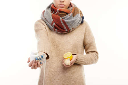 Close up. Woman taking her medical prescription with sliced lemon in her hand.