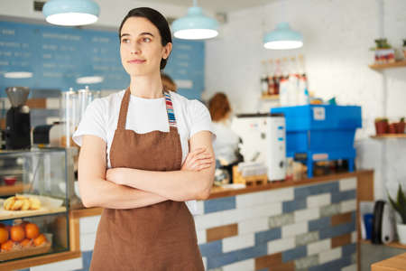 Barista in the apron looking at the camera.の写真素材