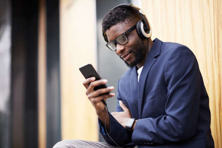 Man in headphones walking down the street.