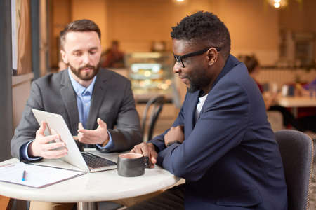 Two businessmen having a look at the computer screen.の写真素材