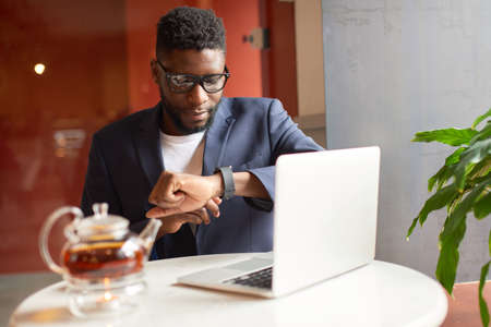 Afro-american working with his laptop in the cafe.の写真素材