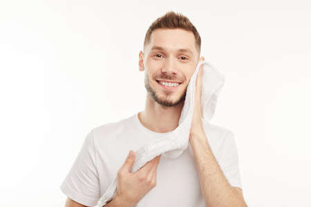 Man wipes water from his face with a towel.の写真素材