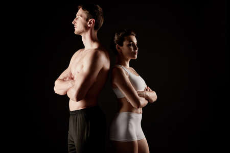 Fit couple in sportswear poses at the camera.