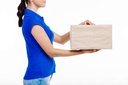 Close up of a girl in blue shirt as she holds a big parcel.の写真素材