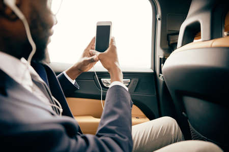 Man taking photos from inside the car with his headphones on.の写真素材