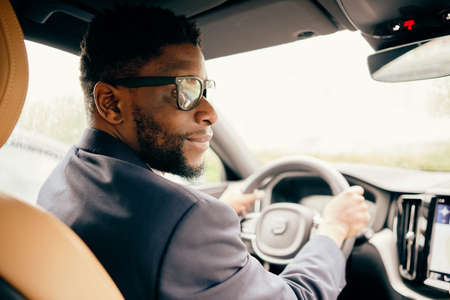 Man making a car ride home from work.