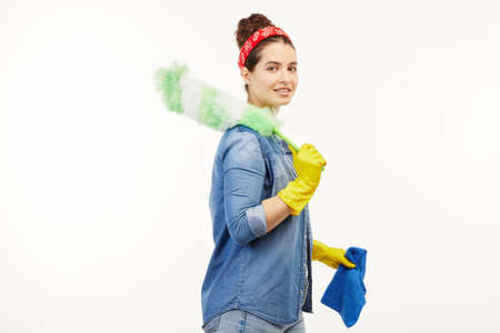 Pretty woman in work-wear uses dust cleaning supplies.の写真素材