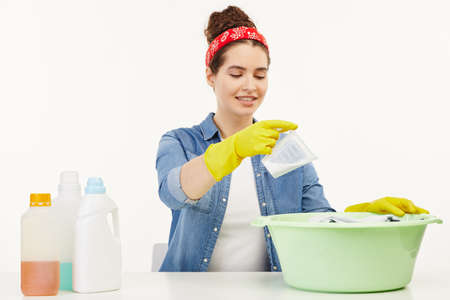 Beautiful woman in her work-wear sits at the table.の写真素材