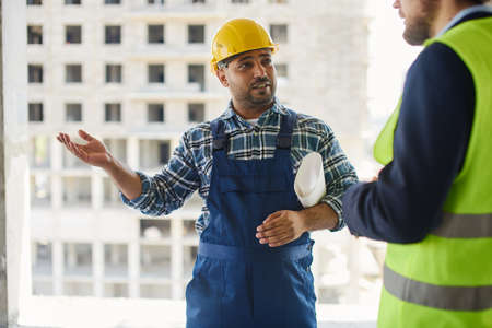 Two engineers discuss work related questions together.