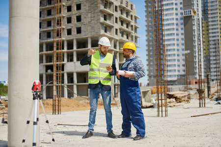 Two engineers discuss work related questions together.