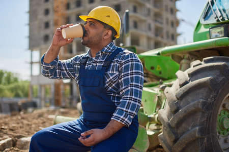 An engineer has his lunch break at the work place.