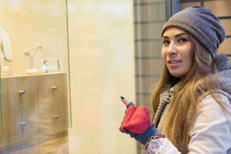 Woman pointing at items in showcaseの写真素材