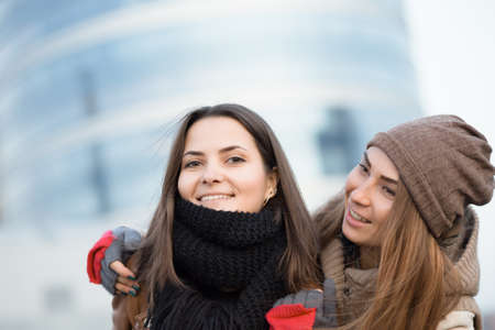 Girlfriend hug in winter cityの写真素材