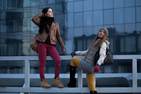 Stylish girlfriend posing in a parking lot in winterの写真素材