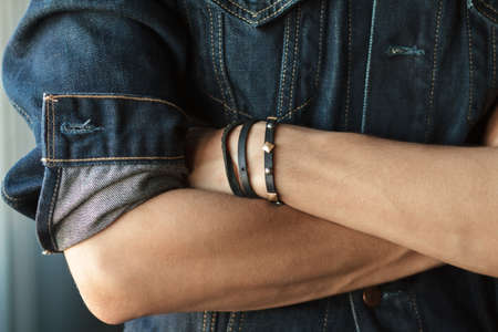 Hands closeup of man in a denim jacketの写真素材