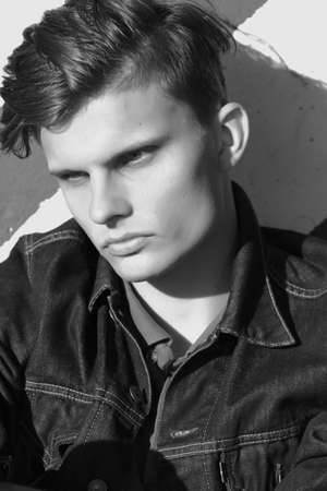 Stylish man sit in a denim jacket