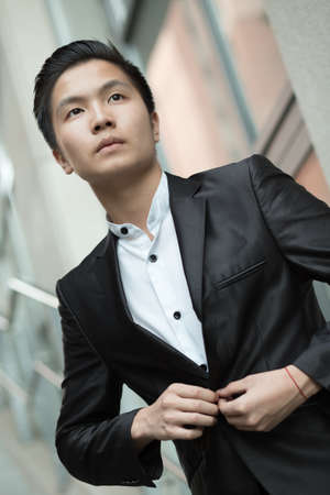 Portrait of chinese elegant businessman near buildingの写真素材