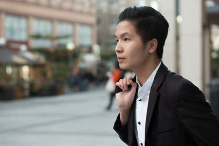 Chinese elegant purposeful businessman in avenueの写真素材