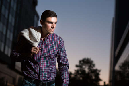 Fashion photo of stylish man in checkered shirt. Building background.の写真素材
