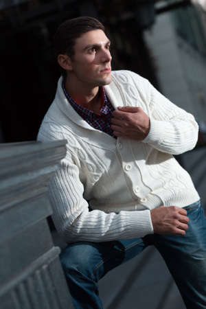 Fashion photo of stylish man in checkered shirt and white pulloverの写真素材