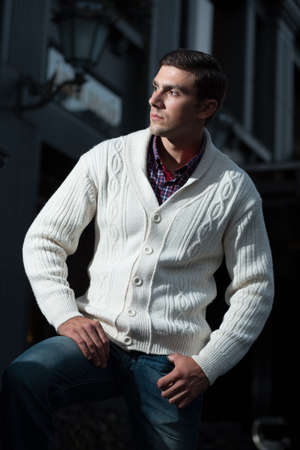 Fashion photo of stylish man in checkered shirt and white pulloverの写真素材