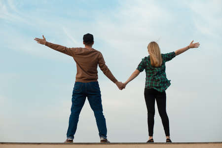 Happy young couple. Blue sky backgrund.の写真素材