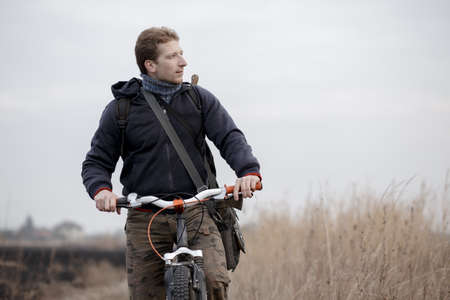 Man tourist riding a bike in fieldの写真素材