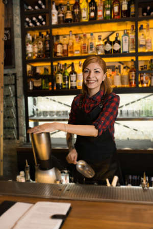 Portrait of woman cafe workers in aprons at the barの写真素材