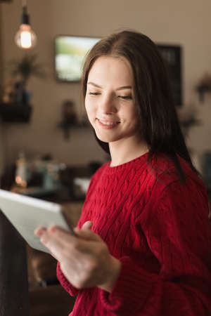 Woman using her digital tablet in coffee shop