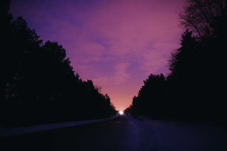 Freeway out of town. Purple sunset in winter.の写真素材