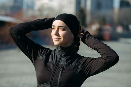 Portrait of athletic woman in cityの写真素材