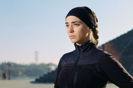 Portrait of young athletic woman in sportswear at cityの写真素材