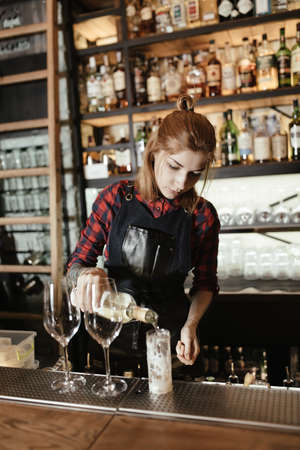 Barista woman prepares a cocktail at the barの写真素材