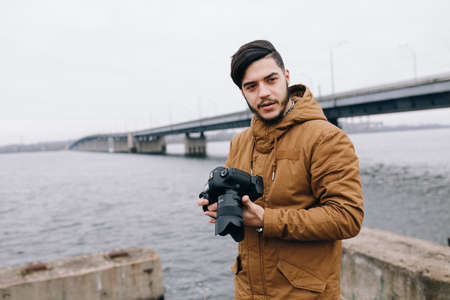 Photographer near river looking for the moment to take a pictureの写真素材
